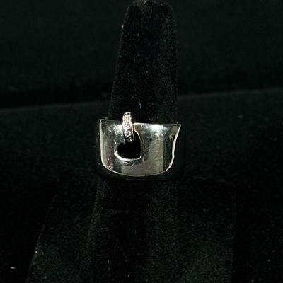 DIAMOND & 14K WHITE GOLD RING | Designed as a substantial 11mm wide band with a small heart-shaped opening mounting a round metal...