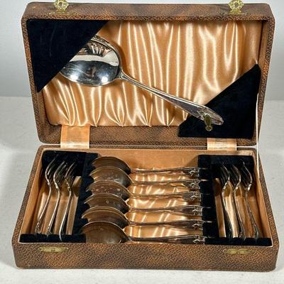 SILVER PLATE DESSERT UTENSIL SET | Including: 6 dessert forks, 6 dessert spoons, and large serving spoon in leather box. - l. 10.5 x w. 7...