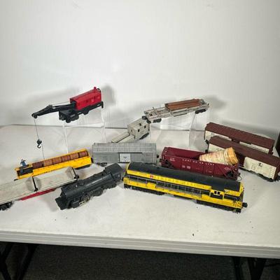 (11PC) VINTAGE LIONEL TRAINS | Including: Bucyrus Erie Crane Car No. 6560, Operating Log Car No. 336115, D.L. & W. Work Caboose No....