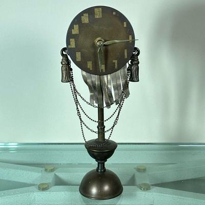 SMALL BRASS CLOCK | Artful brass clock. - l. 5 x w. 3 x h. 12 in

