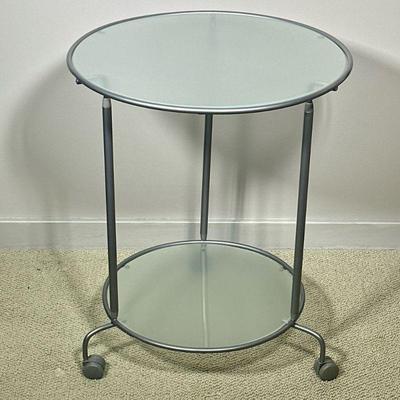 ROLLING ALUMINUM & GLASS SIDE TABLE | Round glass side table with 2 shelves and casters. - h. 24 x dia. 20 in

