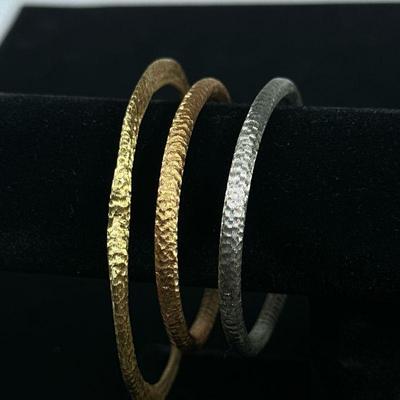 (3PC) 18K GOLD CUCCINIELLO BRACELETS | Comprising: 18K Gold (10.7g), 18K Rose Gold (9.1g), and 18K White Gold (10.1g) textured bracelets,...