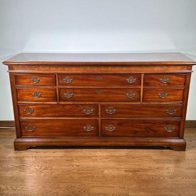 CARVED WOOD DRESSER | Having a half-width drawer flanked by 2 quarter-width drawers over 2 graduated half-width drawers with brass pulls....