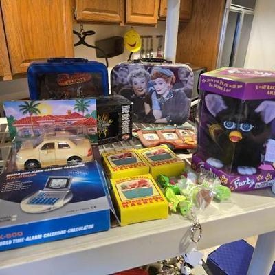 #60810 • (2) Lunchboxes, Refrigerator Magnets, Harley Davison Ceramic Mugs, Furby, and The Chevron Cars Toy
