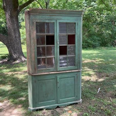 Corner cabinet with early green paint