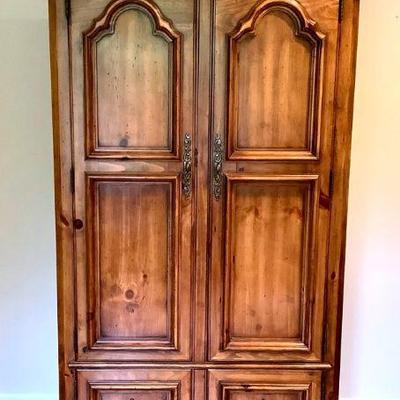 GRLI228 Thomasville Armoire	Made by Thomasville Furniture, 2 large cabinet doors that open up to a couple shelves and 3 cubbies and 2...
