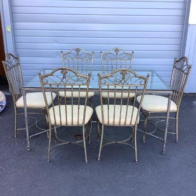 BEDO311 Traditional Design Wrought Iron Table With 6 Chairs	Silver in color table with glass top.  Chairs have a light colder fabric...