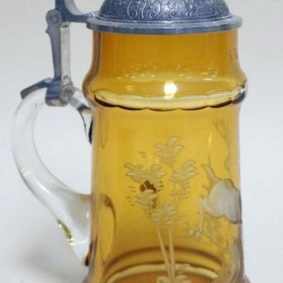 1077	GERMAN BOHEMIAN AMBER GLASS STIEN WITH CUT DESIGN OF STAG RUNNING THROUGH FOREST AND JEWELED GLASS INSET PEWTER LID, APPROXIMATELY...