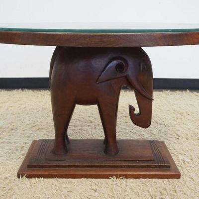 1133	SOLID MAHOGANY OVAL ELEPHANT TABLE WITH GLASS TOP, APPROXIMATELY 35 IN X 24 IN X 22 IN
