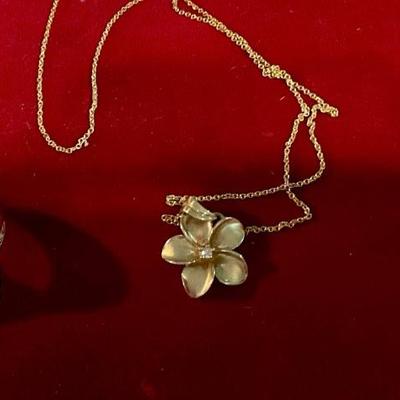 Gold necklace with flower drop