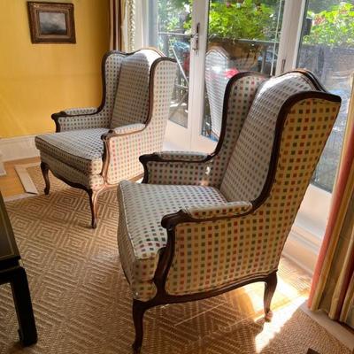 Pair of Louis XV style wingback armchairs with carved wood frames