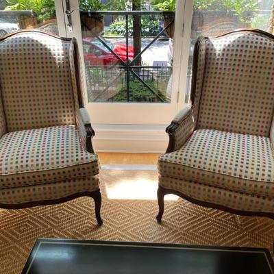 Pair of Louis XV style wingback armchairs with carved wood frames
