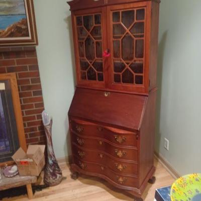 1930-40's drop front secretary with 4 shelves with glass doors, and 4 curved drawers on bottom.