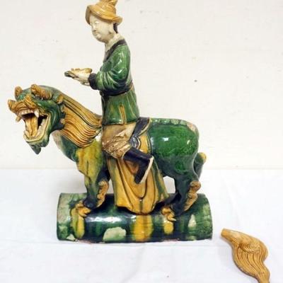 1203	CHINESE LARGE GLAZED TERRACOTTA FIGURE OF MAN RIDING ON THE BACK OF AN ANIMAL, APPROXIMATELY 14 IN X 6 IN X 18 IN H
