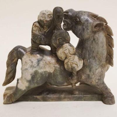 1063	ASIAN CARVED STONE FIGURE OF ASIAN MAN STANDING ON HORSE BACK, APPROXIMATELY 6 1/2 IN X 2 IN X 6 IN HIGH
