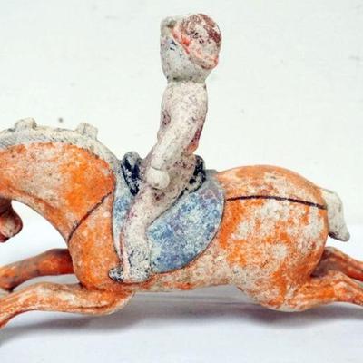 1197	CHINESE POLYCHROME DECORATED POTTERY FIGURE OF MAN RIDING HORSE, APPROXIMATELY 11 IN X 3 IN X 7 IN H
