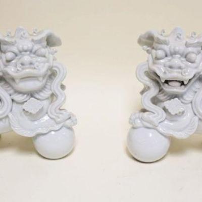 1001	PAIR OF WHITE PORCELAIN FOO DOGS, EACH APPROXIMATELY 10 IN X 5 IN X 8 IN HIGH
