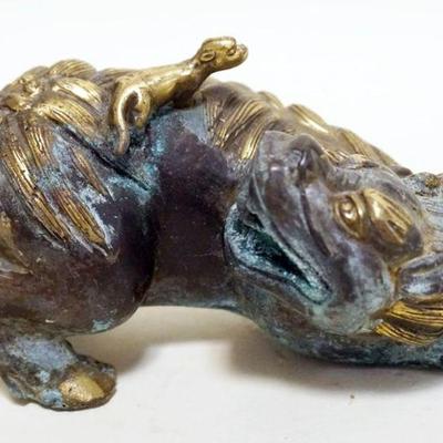 1221	CHINESE BRONZE FOO DOG CARRYING FERRIT ON HIS BACK, APPROXIMATELY 7 IN X 4 IN X 3 IN H

