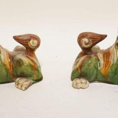 1042	PAIR OF ASIAN POTTERY FOO DOGS, EACH APPROXIMATELY 4 IN X 8 IN X 5 IN HIGH
