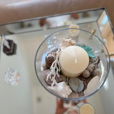arrangement with candle and  sand and shells