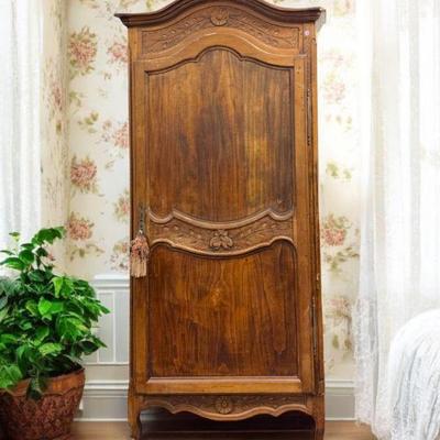 A charming Antique French 18th c. Carved "Bonnetiere" Armoire with 3 shelve interior and key. Measures 30.5" wide 17"...