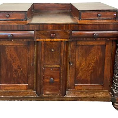 American Late Classical Carved Flame Mahogany Sideboard c. 1825. Blocked backsplash, bolection frieze drawers,3 drawers over 2 deep...