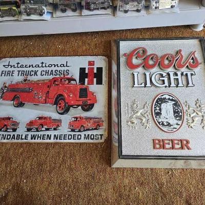#5578 • (1) Metal International Sign and (1) Plastic Coors Light Sign
