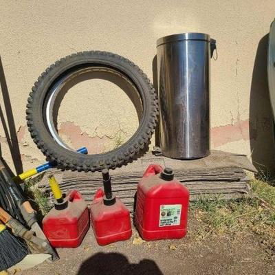 #6018 • Gas Cans, Motorcycle Wheel and Tire, and Trash Can
