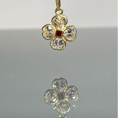 18K GOLD PENDANT | 18k yellow gold flower or clover pendant with four CZs and a red faceted stone in the center, stamped 750 on the...