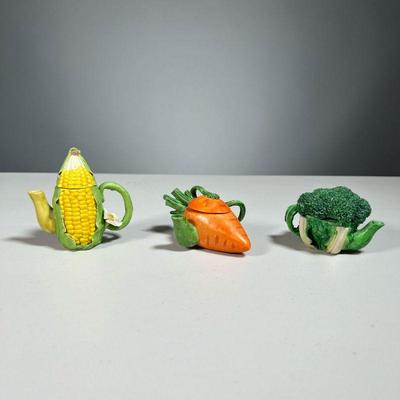 (3PC) MINIATURE TEAPOTS | Adorable miniature vegetable-form ceramic teapots, including carrot, broccoli, and corn, each signed...