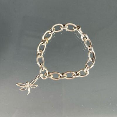 TIFFANY & CO. STERLING DRAGONFLY BRACELET | Designed as a bracelet with alternating oval, silver links, suspending a single dragonfly...
