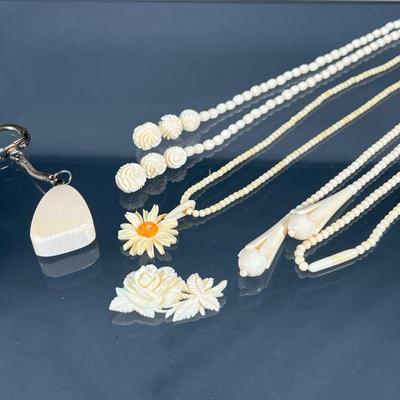 (5PC) CARVED BONE JEWELRY | Antique carved bone jewelry, including a carved floral pin (1-3/4 in.), three beaded necklaces, one having a...