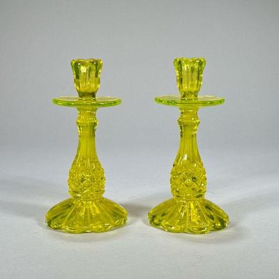 PAIR URANIUM GLASS CANDLESTICKS | Uranium glass candlesticks with flared base. - h. 8.5 x dia. 4 in

