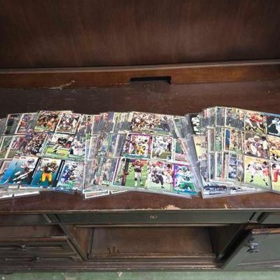 #6026 • (56) Pages of Football Trad ing Cards
