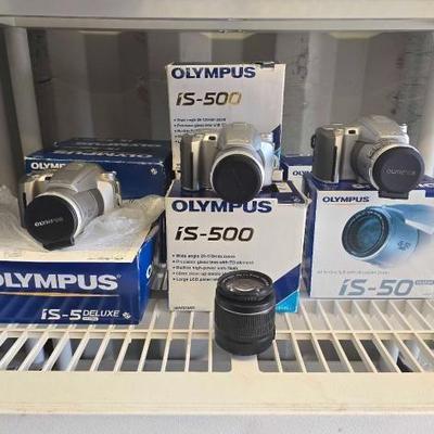 #4074 • (10) Olympus Cameras and (1) Canon 58mm Camera Lense
