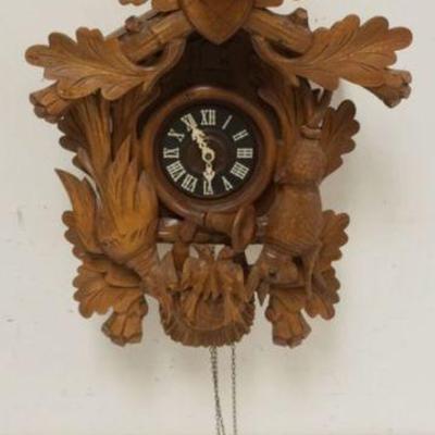 1127	CARVED CUCKOO CLOCK, SOME LOSS TO CARVING, SOLD AS FOUND FOR RESTORATION, APPROXIMATELY 16 IN X 10 IN X 26 IN HIGH
