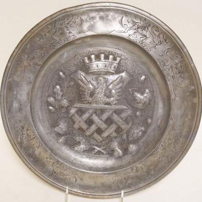 1115	PEWTER CHARGER W/EMBOSSED CREST DESIGN IN CENTER, APPROXIMATELY 13 IN
