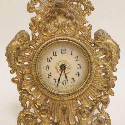1119	ORNATE GILT CAST METAL DRESSER CLOCK, APPROXIMATELY 7 IN HIGH

