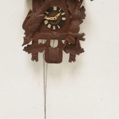 1129	CARVED CUCKOO CLOCK, SOME LOSS TO CARVING, SOLD AS FOUND FOR RESTORATION, APPROXIMATELY 14 IN X 12 IN X 21 IN HIGH
