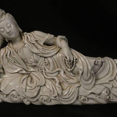 1023	PORCELAIN FIGURE OF ASIAN WOMAN RECLINING, APPROXIMATELY 3 IN X 12 IN X 7 IN HIGH
