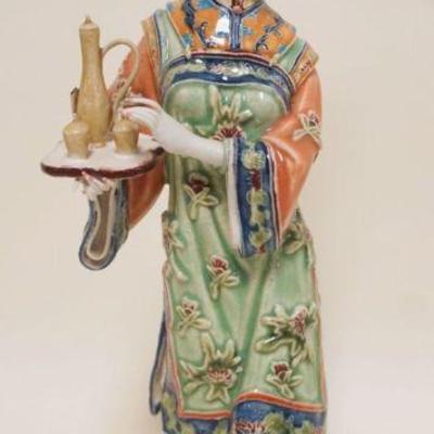 1024	POTTERY FIGURE OF ASIAN WOMAN SERVING TEA, APPROXIMATELY 13 IN HIGH, MARKED INSIDE BASE
