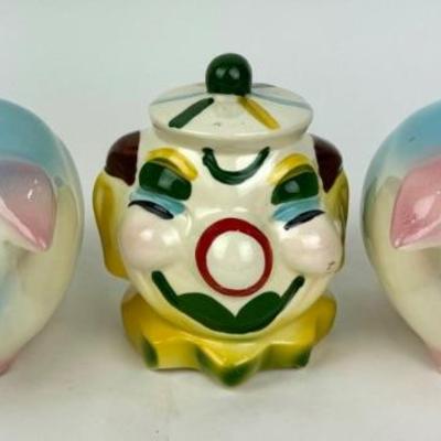 #245 • Two Hull Corky Pig Piggy Banks and USA Clown Bank
WWW.LUX.BID