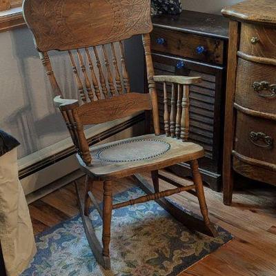 Antique Wooden Rocking Chair with Carved Details & Embossed Leather Seat Insert
