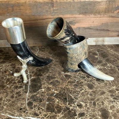 (2pc) Viking Drinking Horns | Two Drinking Horns including: *Horn with brass rim in a horn stand. *Horn with silver tone top and stand. -...