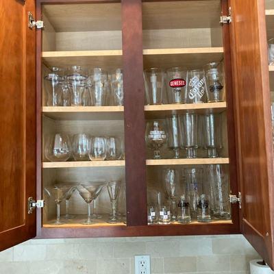 Large Lot of Glassware Stemware | Large Lot of two cupboards full of glassware including: Wines, Martinis, Samuel Adam’s, Guinness, Large...