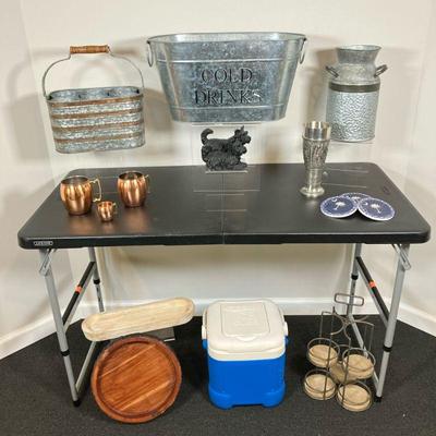 (16pc) Barware Lot | Lot includes: *Cold Drink Galvanized Cooler *Galvanized Cream Can *(3) Copper Mugs *Wood Bark Lazy Susan *White...