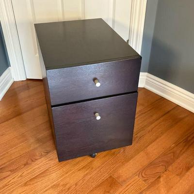 Filing Cabinet | Wood two drawer filing cabinet in black finish with castors. Top drawer and file bottom. - l. 15.75” x w. 23” x h. 23” in

