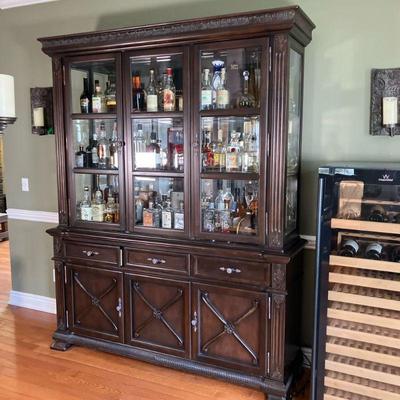Ashley Furniture China Closet | Three Door China Cabinet in a mahogany finish by Ashley Furniture. Shelves are six glass inserts. Three...