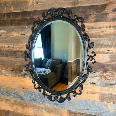 Bronzed Oval Mirror "Quoizel" | Beveled Mirror in a bronze finished iron with scrollwork and leaves design. Tag on front...