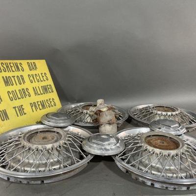 Lot 439 | Vintage Hubcaps & Metal Bar Sign
